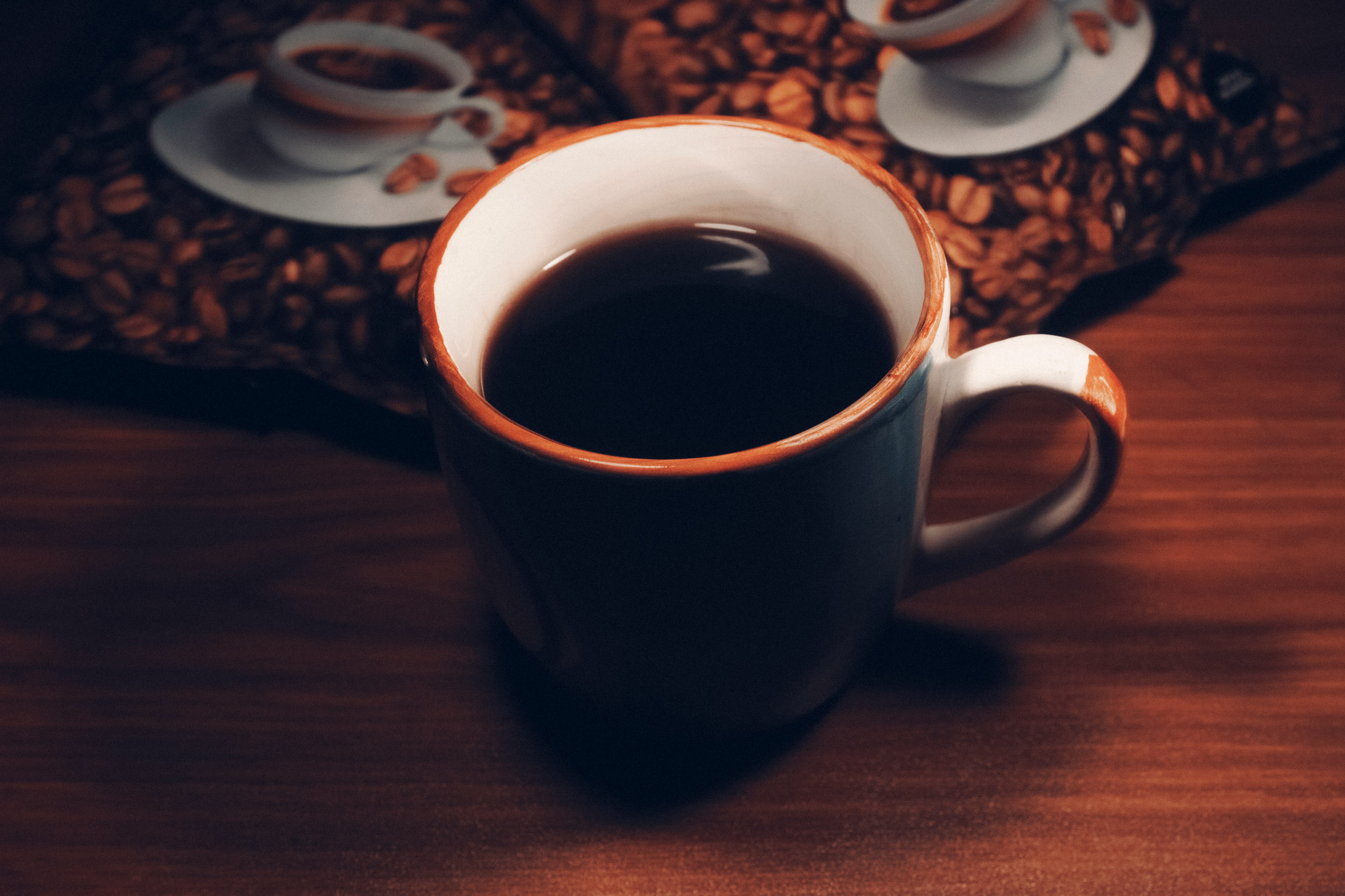 white ceramic mug with black liquid inside